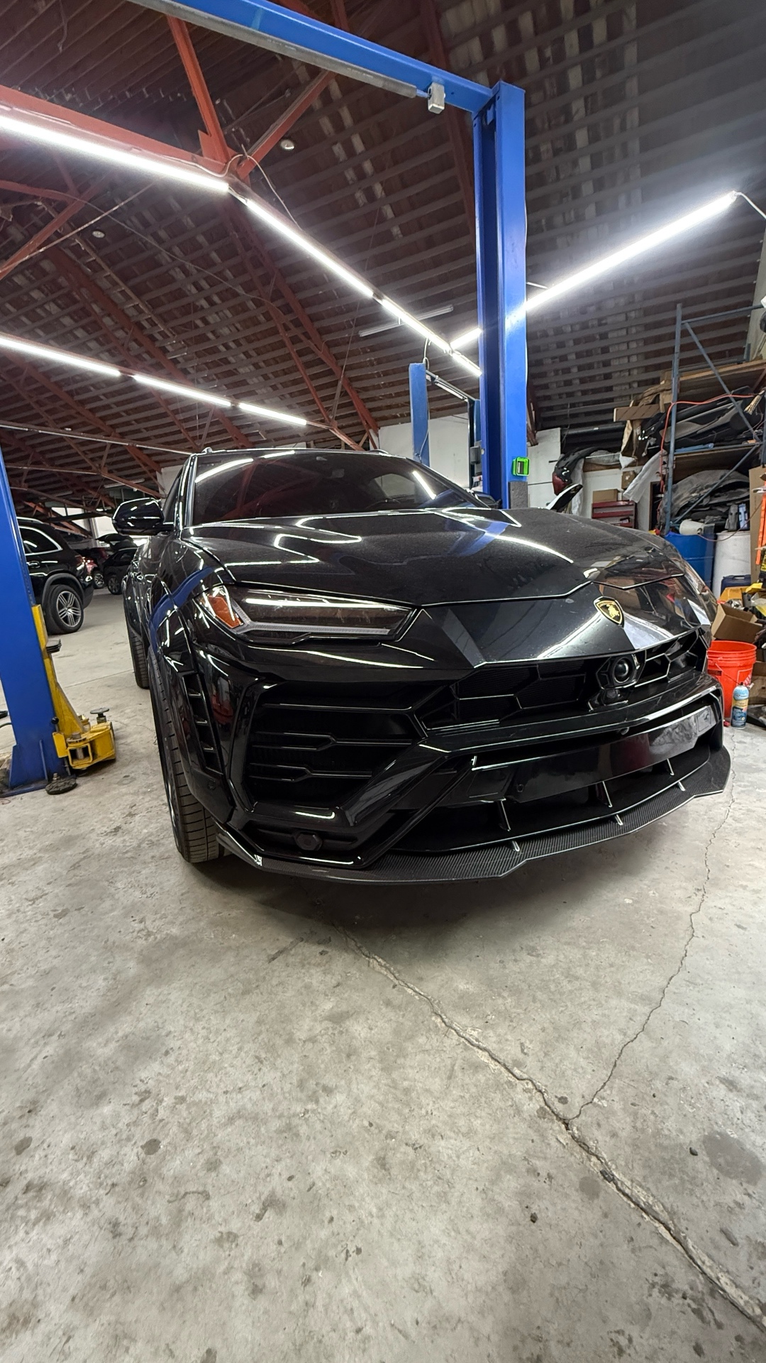 Lamborghini Urus on the lift inside the CarLogic Exotic service bay