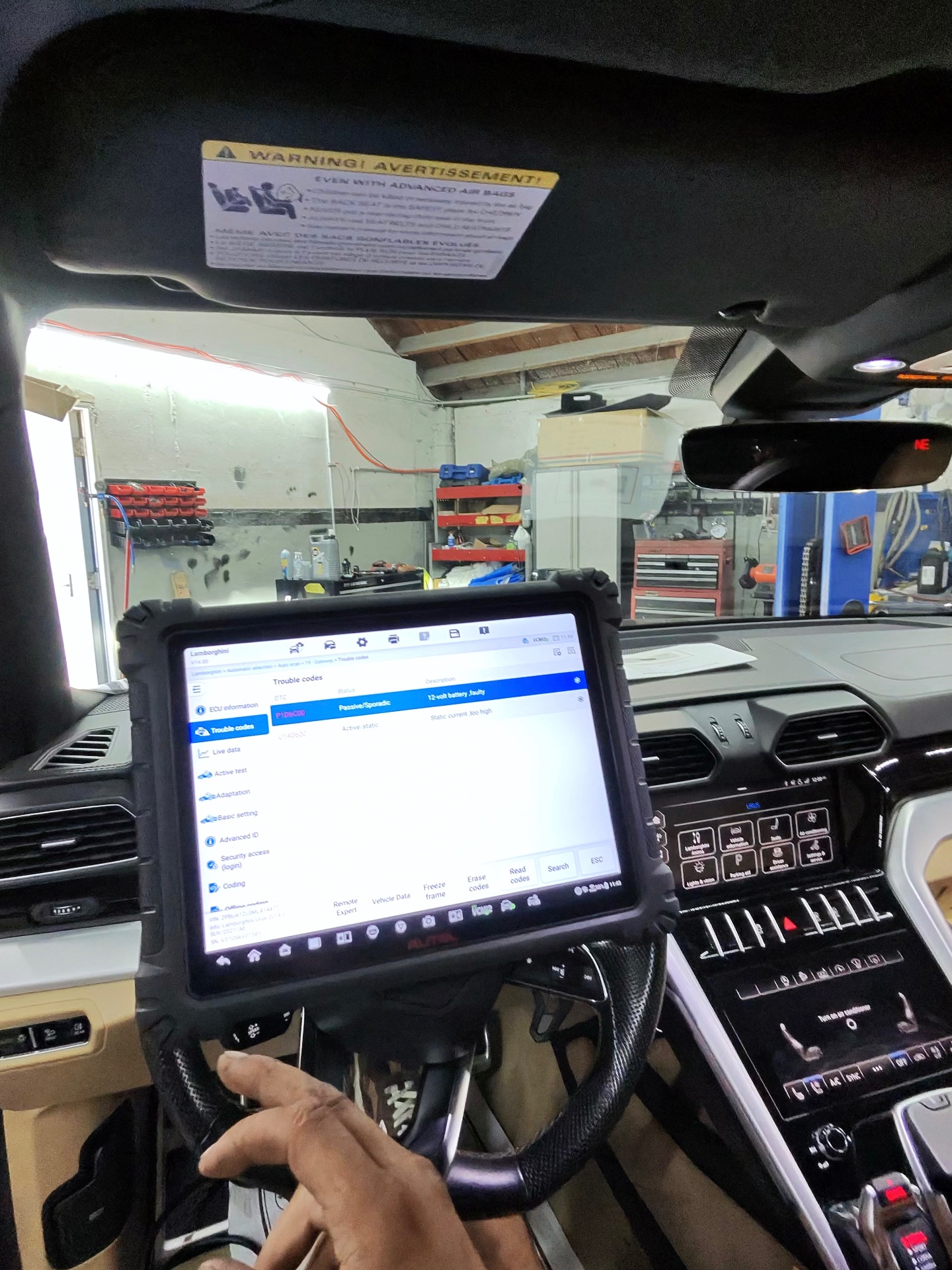 CarLogic Exotic technician running a factory-level diagnostic scan inside a Lamborghini Urus